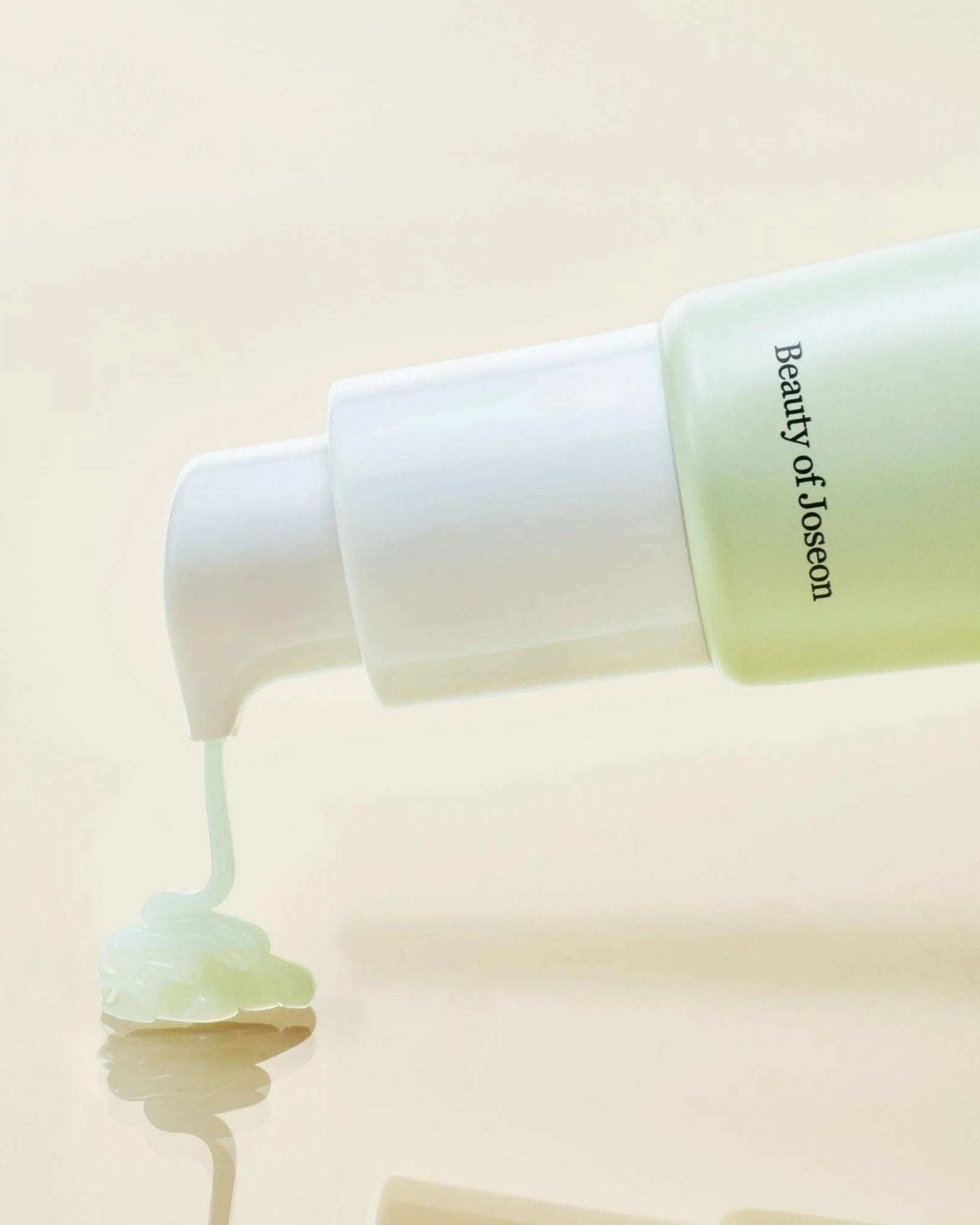 Beauty of Joseon skincare product being applied with a white applicator on a beige background
