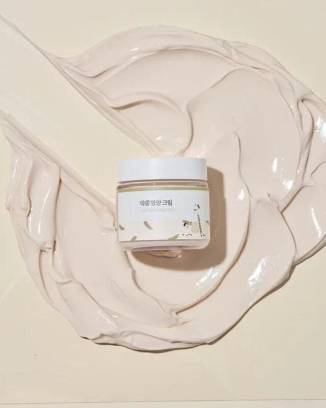 Jar of cream on a beige fabric background