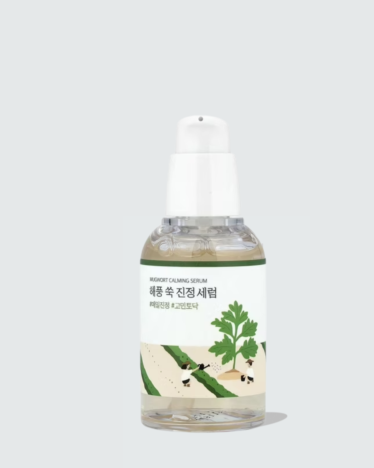 Serum bottle with a label featuring green leaves on a light gray background