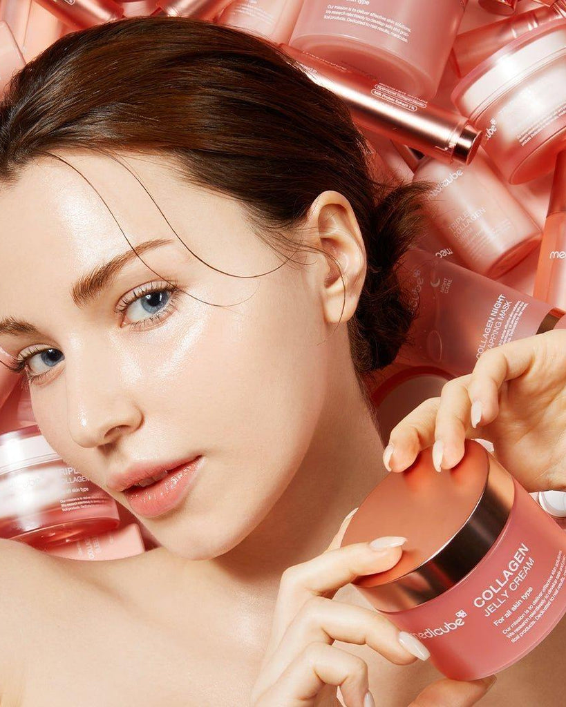 Woman holding a pink collagen jar with skincare products in the background