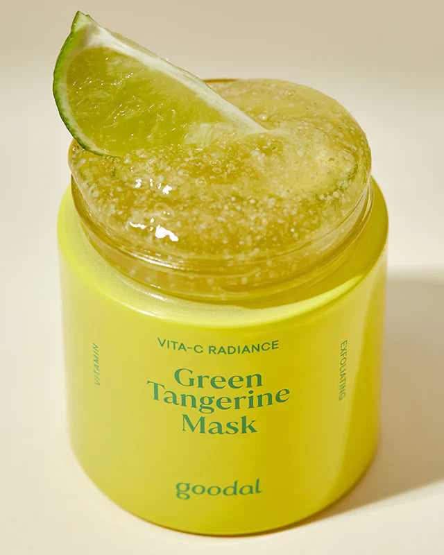 Yellow jar of Green Tangerine Mask with a lime wedge on a beige background